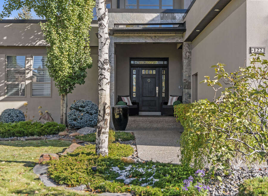 This stunning property boasts a modern facade with a welcoming entrance.