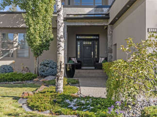 This stunning property boasts a modern facade with a welcoming entrance.