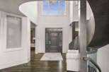 Step into luxury with this stunning entryway, showcasing a grand staircase and soaring ceilings.