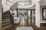 Step into luxury with this stunning home featuring a grand, curved staircase and exquisite hardwood floors.