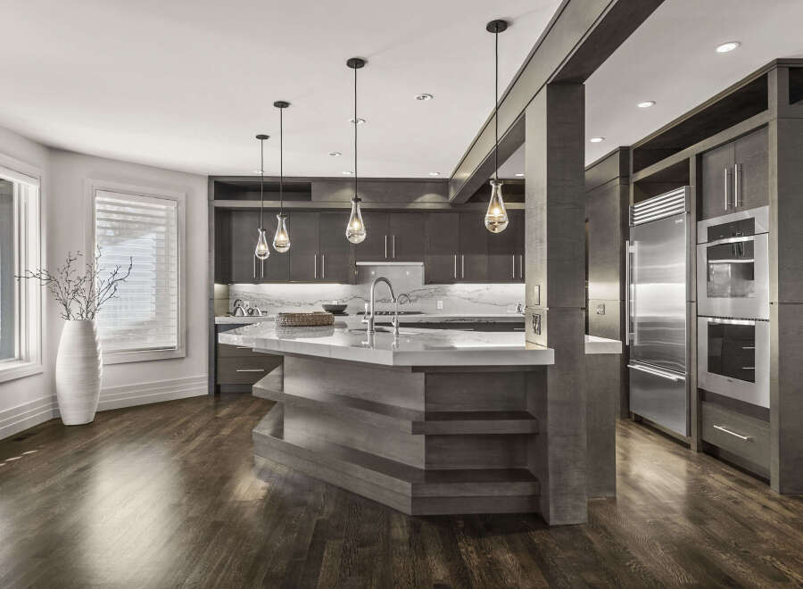 This stunning kitchen boasts a modern design with sleek cabinetry and a spacious island.