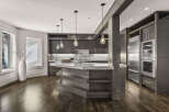 This stunning kitchen boasts a modern design with sleek cabinetry and a spacious island.
