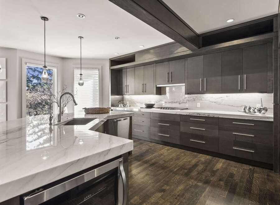 This stunning kitchen boasts a modern design with sleek cabinetry and a spacious island.