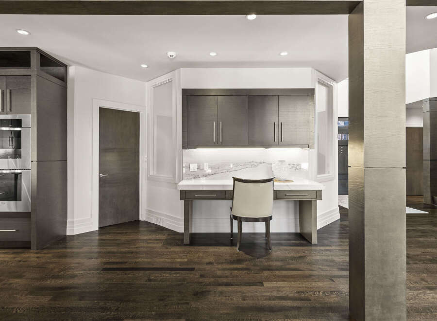 This stunning property boasts a modern interior with dark wood flooring and sleek cabinetry.