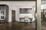 This stunning property boasts a modern interior with dark wood flooring and sleek cabinetry.