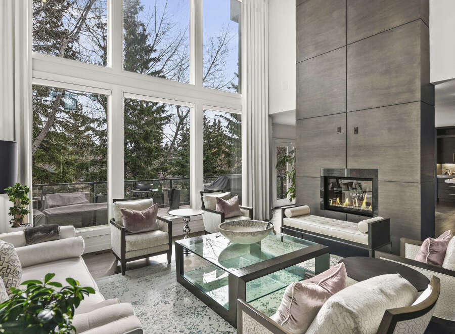 Experience luxury living in this stunning property featuring a modern fireplace and expansive windows that flood the space with natural light.