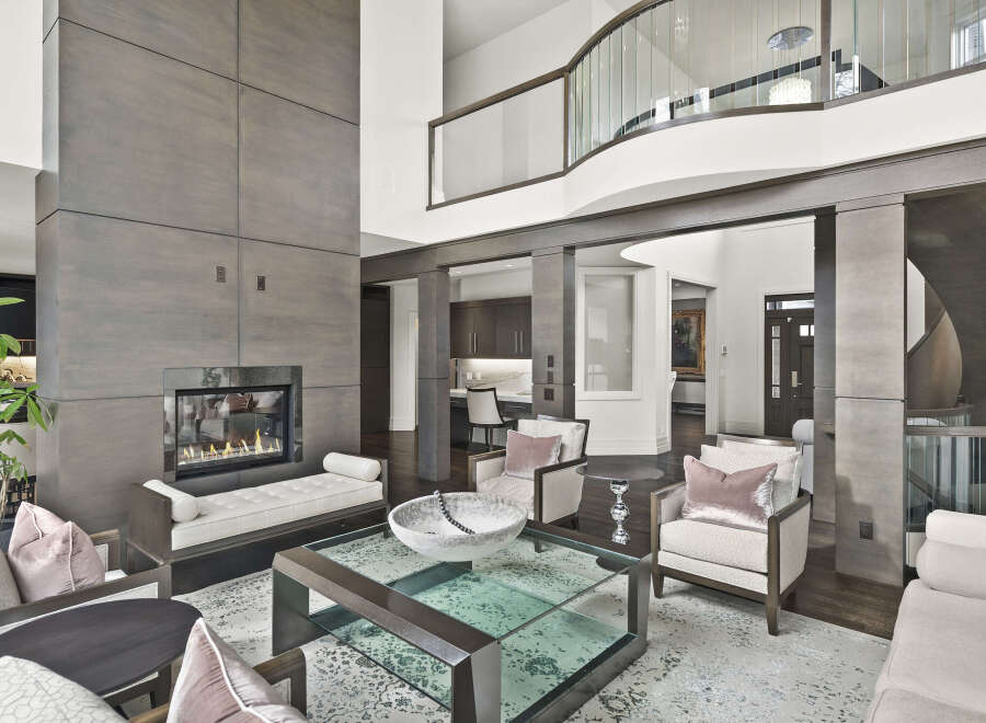 Step into luxury with this stunning property, showcasing a modern living space with a cozy fireplace and elegant seating.