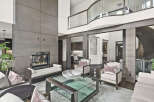Step into luxury with this stunning property, showcasing a modern living space with a cozy fireplace and elegant seating.
