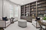 Step into luxury with this stunning home office, featuring custom built-in shelving and ample storage.