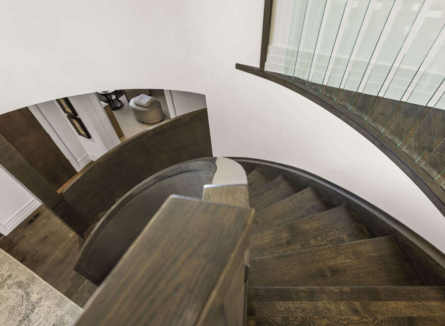 This stunning property boasts a beautifully designed curved staircase, a true architectural highlight.