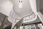 This stunning property features a grand, curved staircase, a focal point of the home's elegant design.