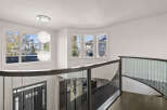 This stunning property features a grand entryway with a modern staircase and elegant glass railings.