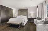 Step into luxury with this stunning bedroom featuring a plush, tufted headboard and a comfortable bed.