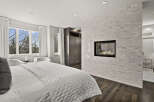 Experience luxury in this stunning bedroom featuring a modern fireplace and elegant design.