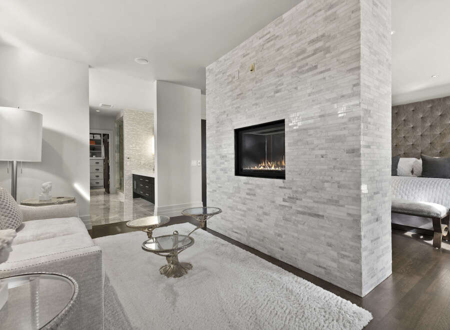 Experience luxury living in this stunning property featuring a modern fireplace, perfect for cozy evenings.
