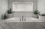 Indulge in the luxury of this spa-like bathroom, featuring a pristine white bathtub and elegant marble accents.
