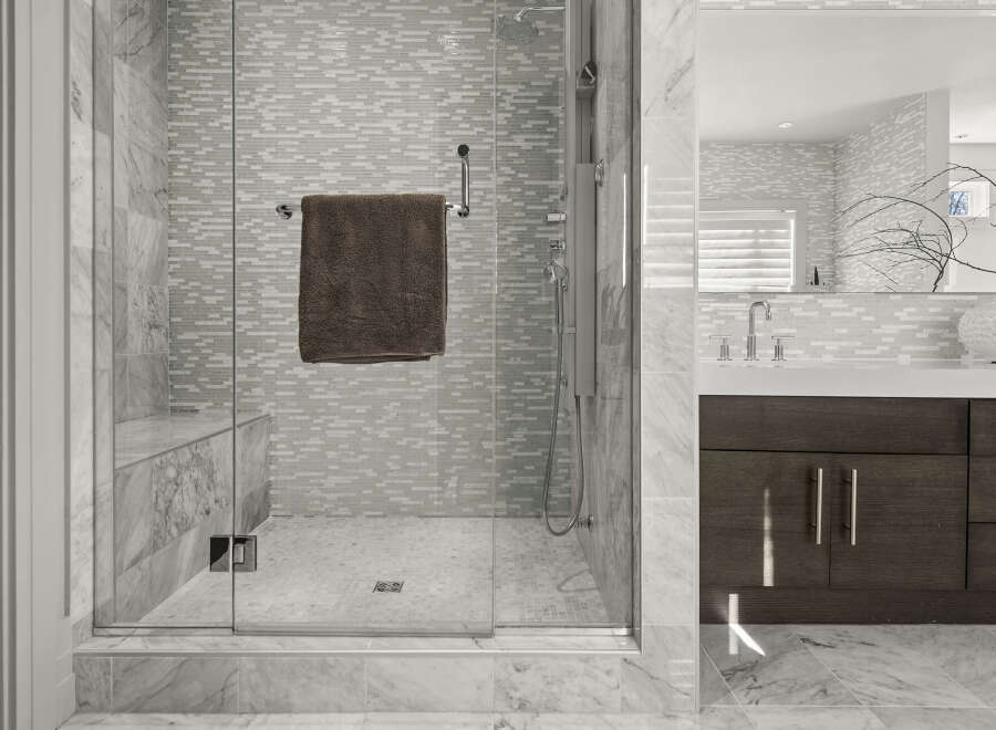 Step into luxury with this stunning bathroom featuring a glass-enclosed shower.