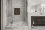 Step into luxury with this stunning bathroom featuring a glass-enclosed shower.