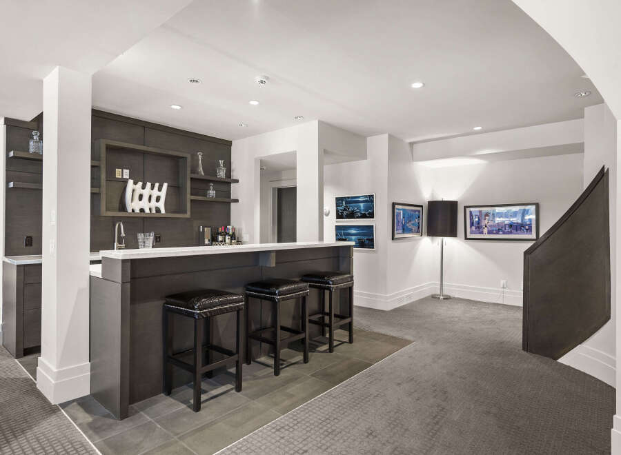 This stunning property boasts a modern bar area, perfect for entertaining guests.