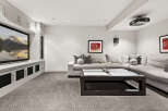 This stunning living room boasts a modern design with a large sectional sofa, perfect for relaxing and entertaining.