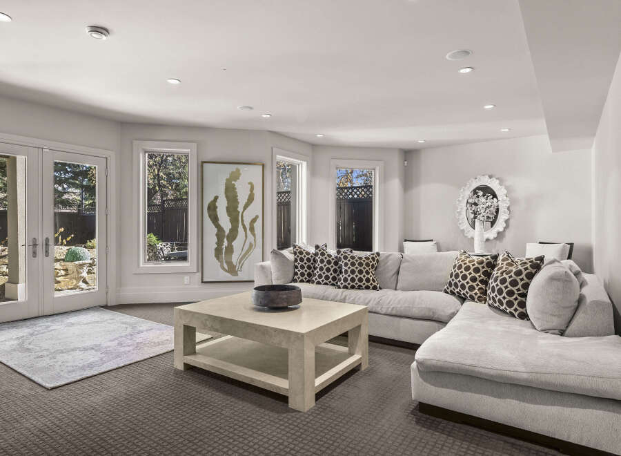 Step into luxury with this stunning living room, featuring a modern sectional sofa and a stylish coffee table.
