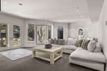 Step into luxury with this stunning living room, featuring a modern sectional sofa and a stylish coffee table.