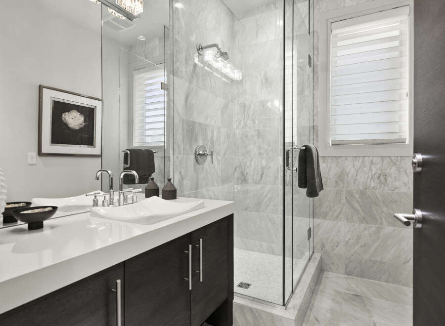 Step into luxury with this stunning bathroom! Featuring a sleek, modern design, this space boasts a spacious glass shower, elegant marble tiling, and a stylish vanity.