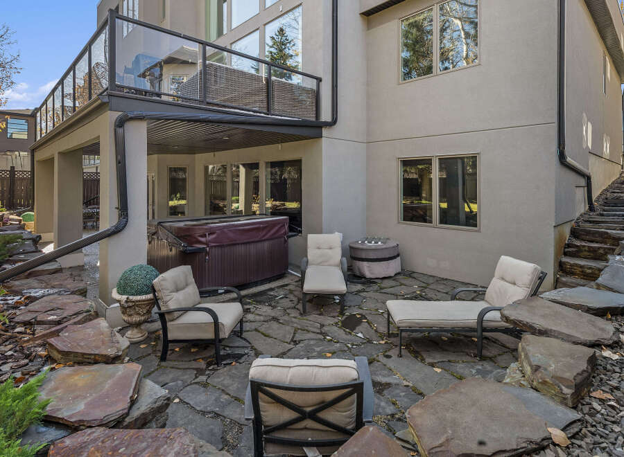 Enjoy outdoor living at its finest with this stunning property featuring a spacious patio and a luxurious hot tub.
