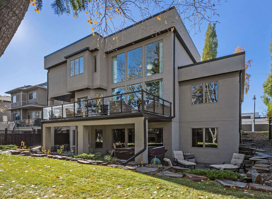 This stunning modern home boasts a sleek exterior and expansive windows, offering abundant natural light.