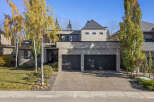 This stunning modern home boasts a sleek exterior with a two-car garage and a beautifully landscaped front yard.