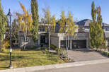 This stunning modern home boasts a sleek exterior design with a spacious driveway and lush landscaping.