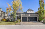 This stunning modern home boasts a sleek exterior with a two-car garage and a beautifully landscaped front yard.