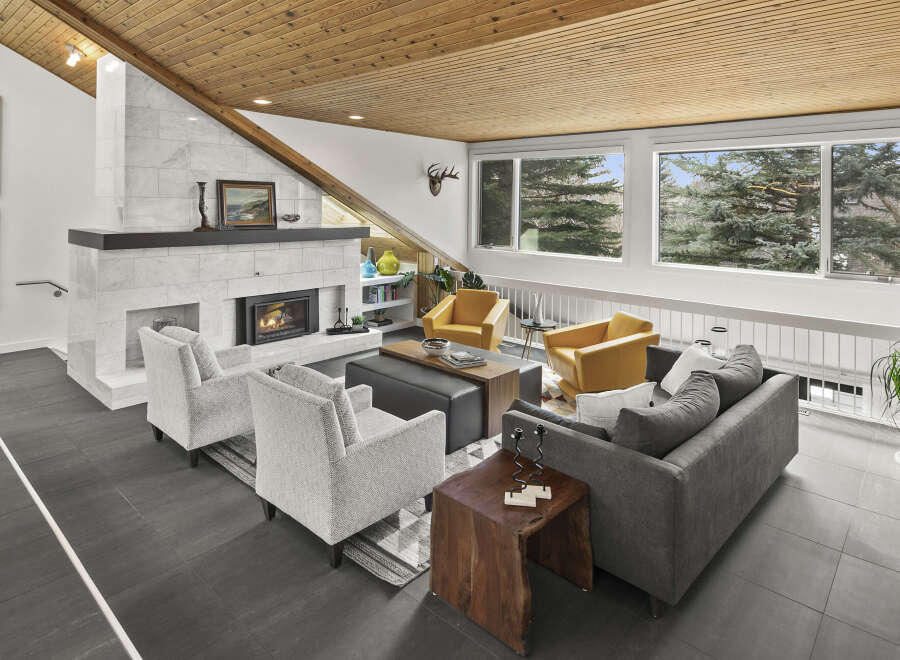 Step into luxury with this stunning living room, featuring a cozy fireplace and stylish seating.