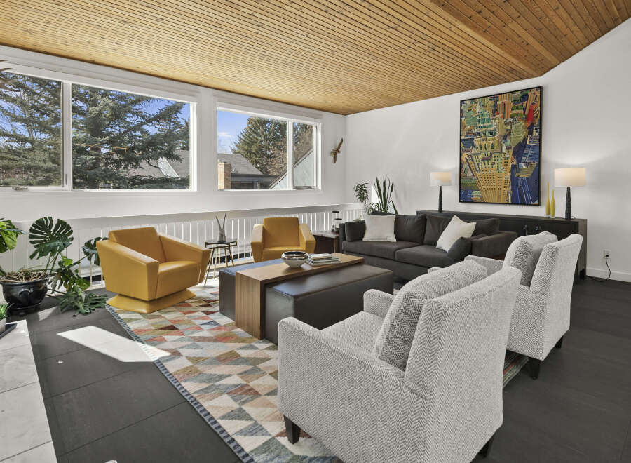This stunning living room boasts a mid-century modern design with a warm, inviting atmosphere.