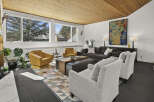 This stunning living room boasts a mid-century modern design with a warm, inviting atmosphere.