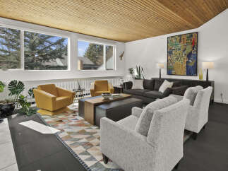 This stunning living room boasts a mid-century modern design with a warm, inviting atmosphere.