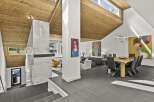 This stunning modern home boasts a unique architectural design with a vaulted wood ceiling and an open floor plan.