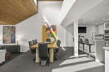 This stunning modern dining room boasts a sleek design with a beautiful wooden table and stylish black chairs.