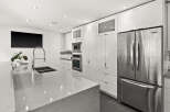 This modern kitchen boasts sleek, white cabinetry and stainless steel appliances, creating a bright and inviting space.