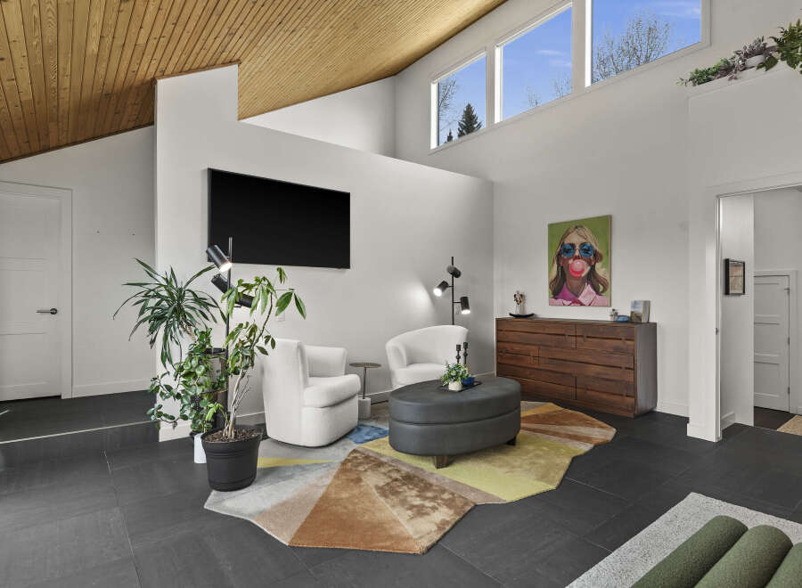 Step into modern luxury with this stunning property, featuring a spacious living area with high ceilings and a stylish design.