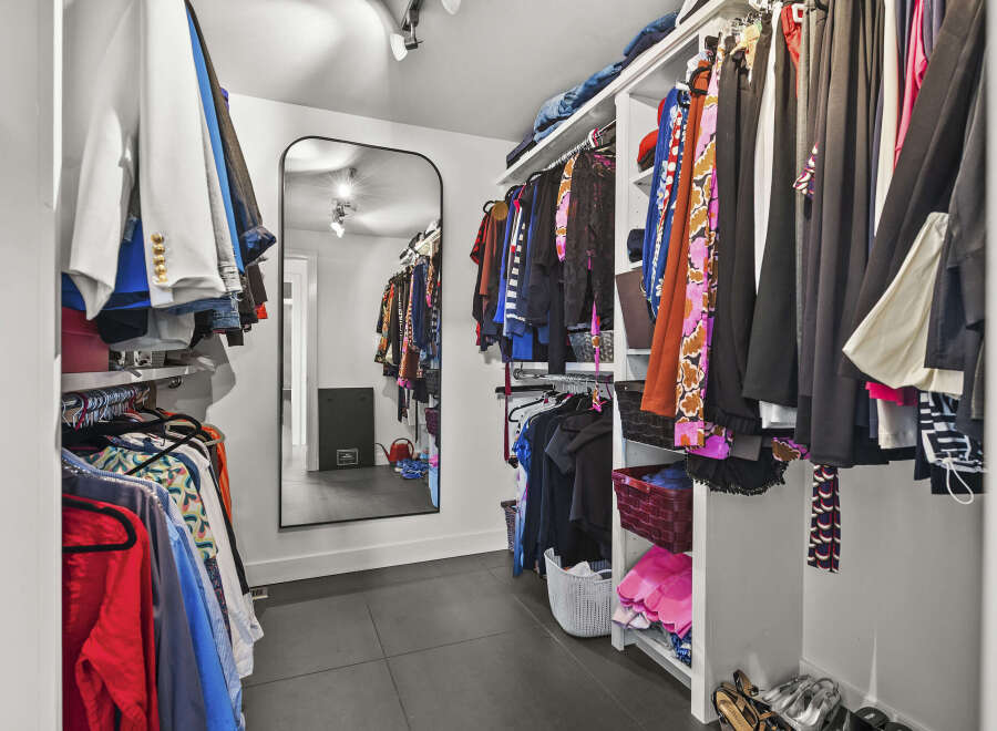 Step into luxury with this meticulously designed walk-in closet, offering ample storage and organization.