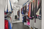 Step into luxury with this meticulously designed walk-in closet, offering ample storage and organization.