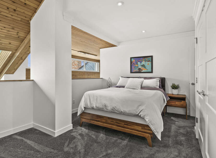 This stunning bedroom boasts a modern design with a touch of warmth.