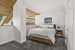 This stunning bedroom boasts a modern design with a touch of warmth.