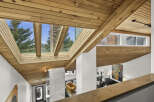 This stunning property boasts a unique architectural design, featuring a striking wooden ceiling and expansive skylights that flood the interior with natural light.