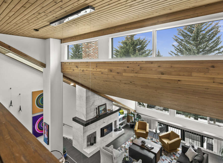 This stunning property boasts a modern design with high ceilings and expansive windows that flood the space with natural light.