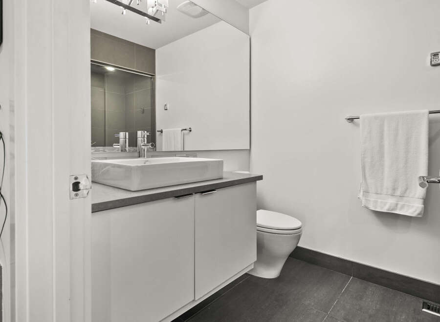 This modern bathroom boasts a sleek design with a minimalist aesthetic.