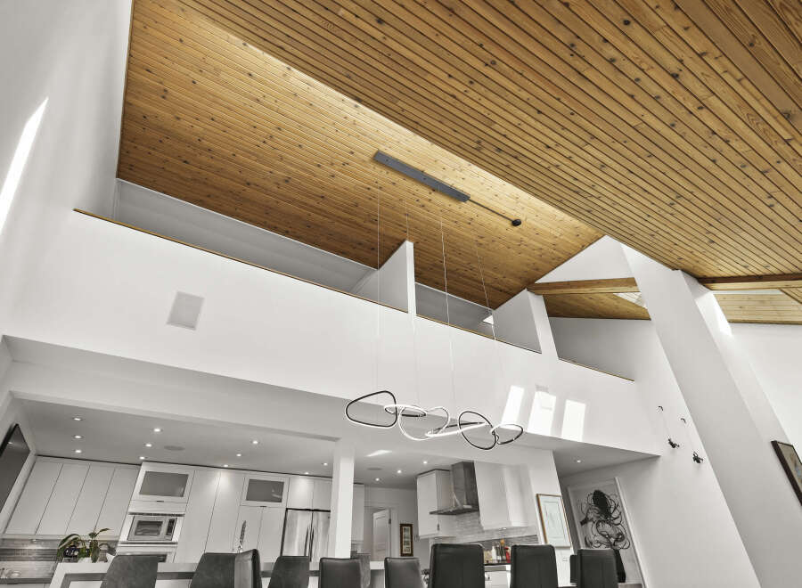 This stunning property boasts a modern design with a unique wooden ceiling that adds warmth and character.