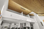 This stunning property boasts a modern design with a unique wooden ceiling that adds warmth and character.