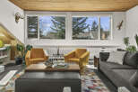Step into this inviting living space, featuring a cozy seating area with two stylish yellow armchairs and a comfortable gray sofa.